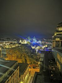 High angle view of illuminated buildings in city at night