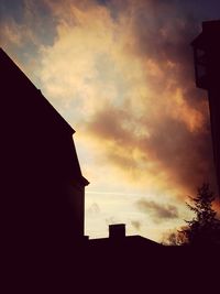 Silhouette of building against sky at sunset