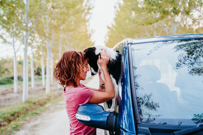 Rear view of woman with umbrella in car