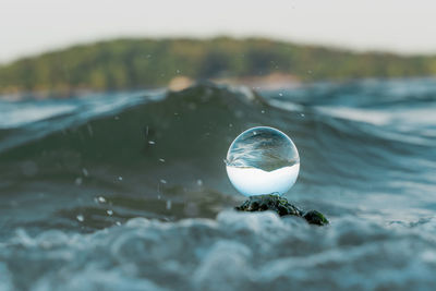 Close-up of bubbles against sea
