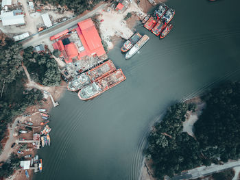 High angle view of boats in river by city