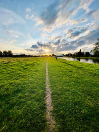 Scenic view of field against sky during sunset