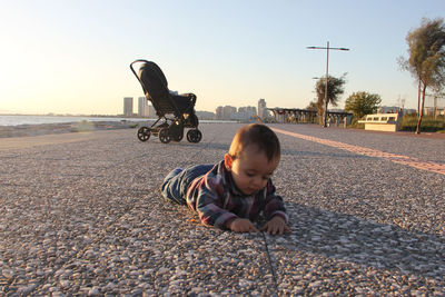 Boy on road against sky