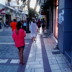 Woman standing on city street