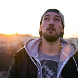 Portrait of young man standing against clear sky