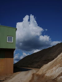 Scenic view of mountains against blue sky