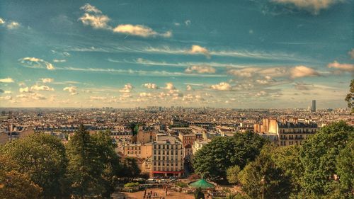 Cityscape against cloudy sky