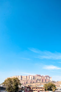 Low angle view of buildings against blue sky