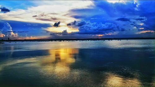 Scenic view of sea against cloudy sky