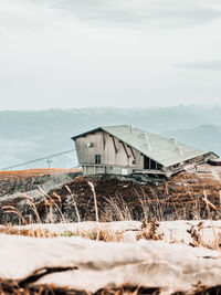 Scenic view of mountain chalet against sky