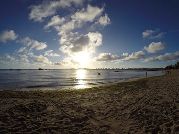 View of beach against cloudy sky