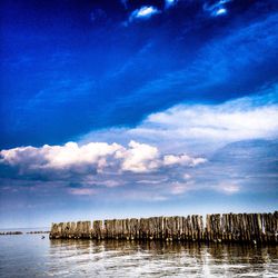 Scenic view of sea against cloudy sky