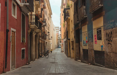 Narrow alley amidst buildings in city