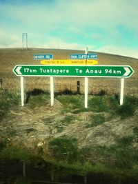 Low angle view of road sign against sky