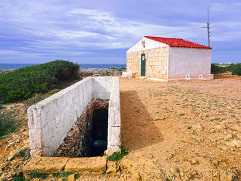 Built structure on beach against sky
