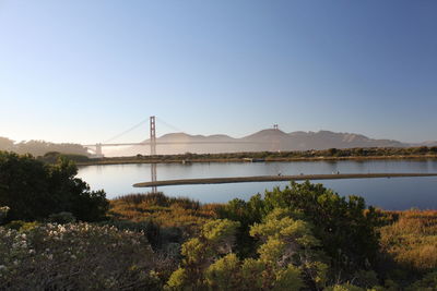 Scenic view of lake against clear blue sky