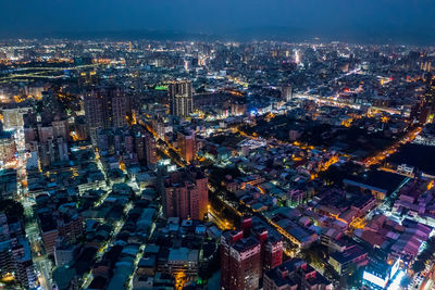 High angle view of illuminated city buildings at night