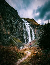 Scenic view of waterfall against sky