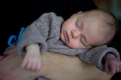 Portrait of newborn baby girl held by her father