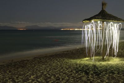 Scenic view of beach against sky at night