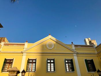 Low angle view of building against clear blue sky