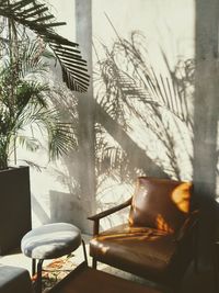 Empty chairs and table by window