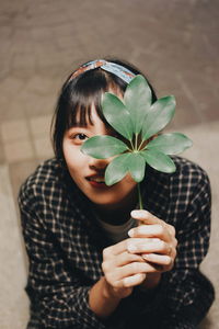 Close-up of girl holding plant