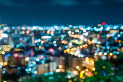 Defocused image of illuminated city at night