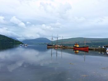 Boats moored on sea against sky