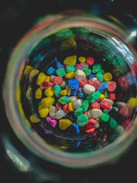 Close-up of multi colored glass in jar