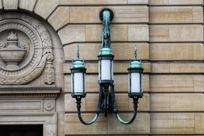 Close-up of electric lamp against wall