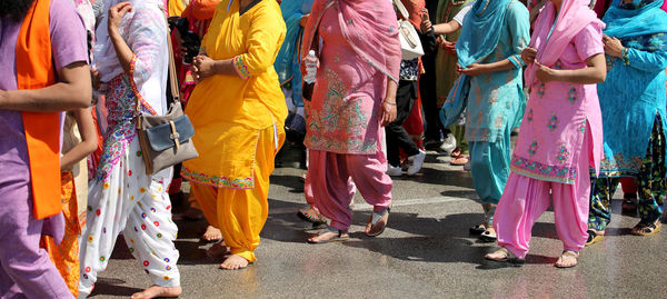 Low section of people standing on street