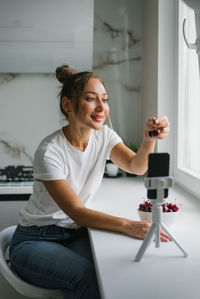 Female nutritionist blogger leads a live broadcast or video conference about the benefits