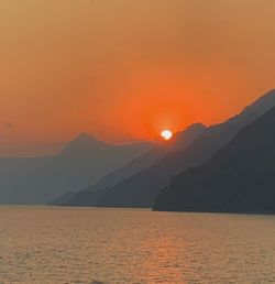 Scenic view of sea against orange sky