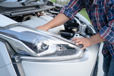 Midsection of man washing car