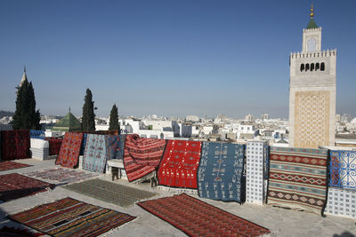 Buildings in city against clear sky