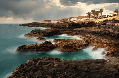 Beautiful rocky coast seascape scenery with small village, charco del palo, lanzerote, canaries