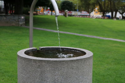 Close-up of water on grass in lawn at park