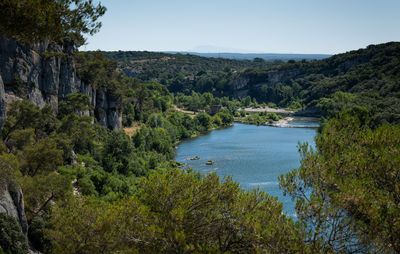 Scenic view of river amidst trees against clear sky