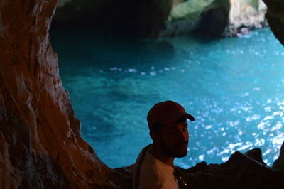 High angle portrait of young man standing in grotto