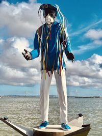 Full length of person standing on sea against sky