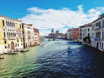 Canal amidst buildings in venice, italy