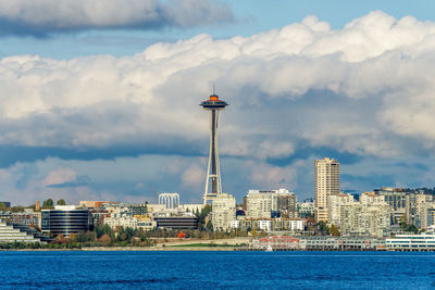 Architecture of the seattle skyline with elliott bay in front and clouds above.