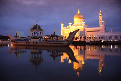 Boat on pool at illuminated sultan omar ali saifuddin mosque