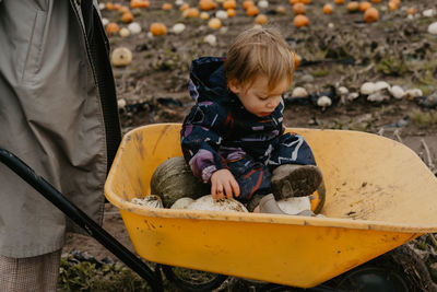 Portrait of cute girl sitting on rock
