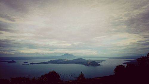 Scenic view of lake against sky at sunset