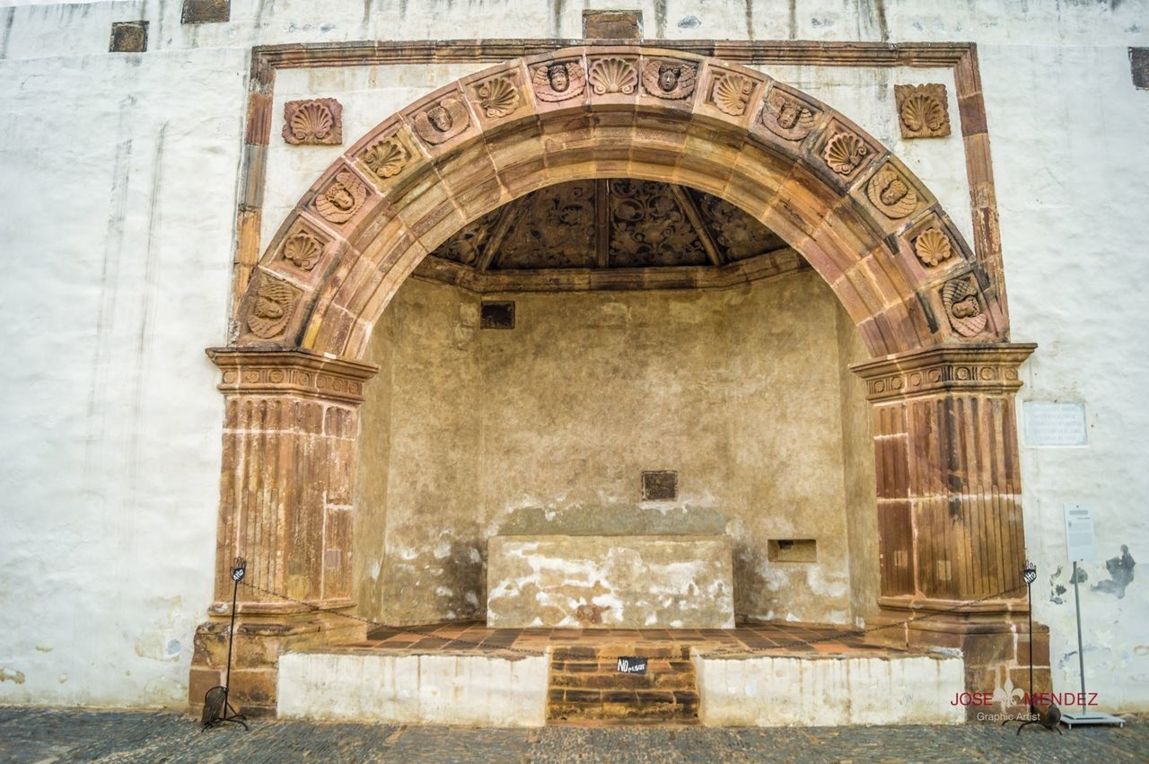 architecture, built structure, building exterior, arch, entrance, door, old, wall - building feature, building, facade, day, window, outdoors, history, low angle view, closed, architectural column, gate, no people, wall