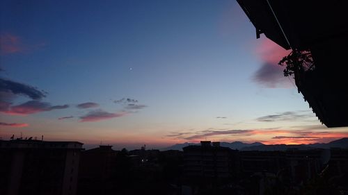 Low angle view of silhouette buildings against sky during sunset