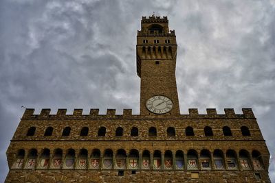 Low angle view of clock tower against sky