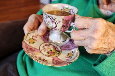 Close-up of hand holding tea cup